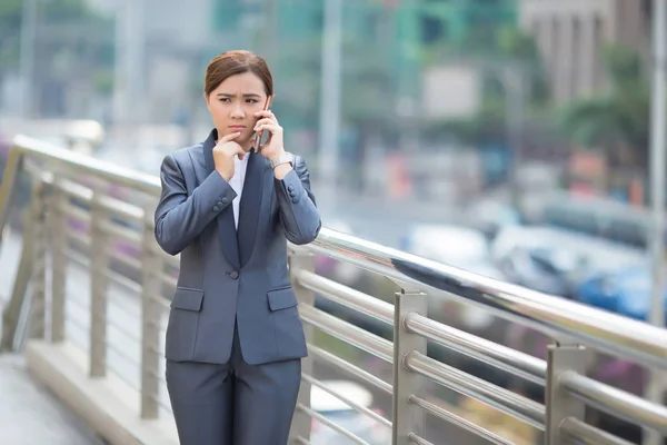 Frau telefoniert mit dem Smartphone und ist traurig — Stockfoto