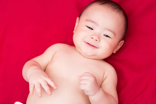 Happy asian baby on red background — Stock Photo, Image