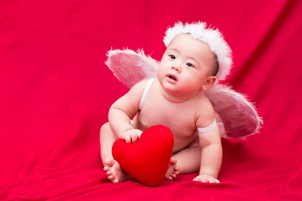 Baby cupid on red background — Stock Photo, Image