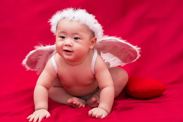 Baby cupid on red background — Stock Photo, Image