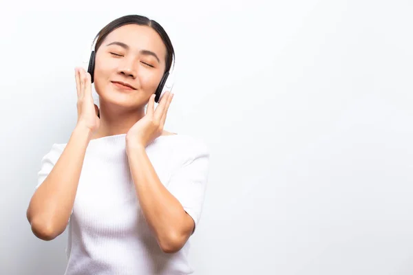 Woman in headphones listening to music isolated over white backg — ストック写真