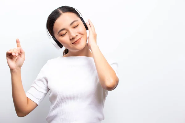 Woman in headphones listening to music isolated over white backg — ストック写真