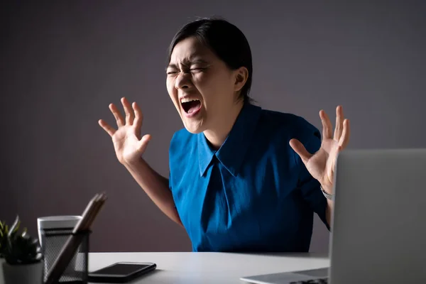 stock image Asian woman in blue shirt angry and shouting, at office. isolated on background. Low key.