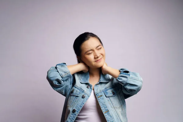 Asian woman was sick with body pain touching her body and standing isolated on white background.