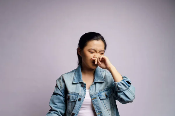 Asian woman was sick with fever, coughing sneezing and standing isolated on white background.