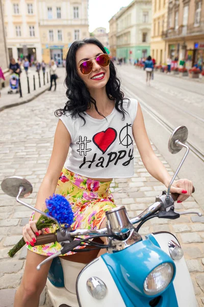 young beautiful woman riding on motorbike city street, summer europe vacation, traveling, smiling, happy, having fun, sunglasses, stylish outfit, adventures, hipster outfit
