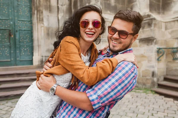 young couple in love traveling, vintage style, europe vacation, honey moon, sunglasses, old city center, happy positive mood, smiling, embracing