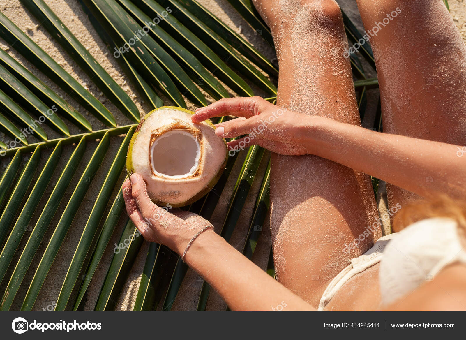 young skinny woman in white bikini swimwear holding coconuts Stock Photo by  marymandarinka