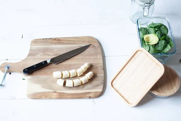 Wooden cutting board and glass jars for vegetables