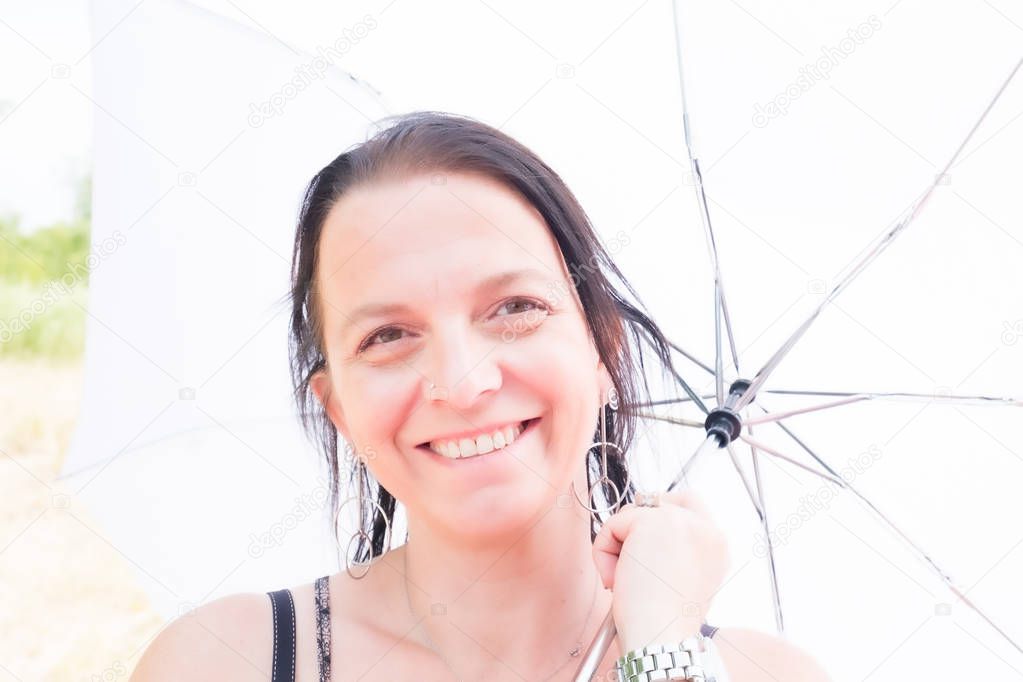 Beautiful woman holding an umbrella for the sun