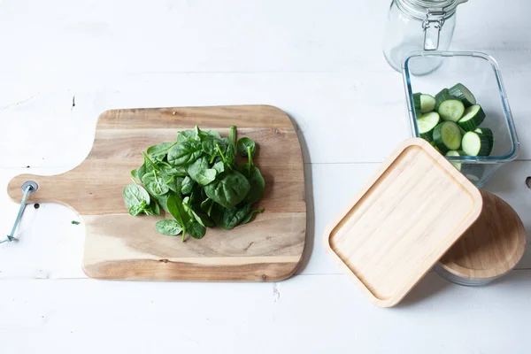 Wooden cutting board and glass jars for vegetables
