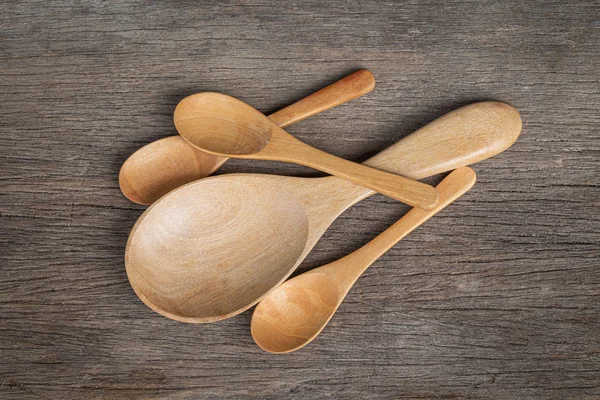 Wooden spoon and wooden ladle on a wooden background