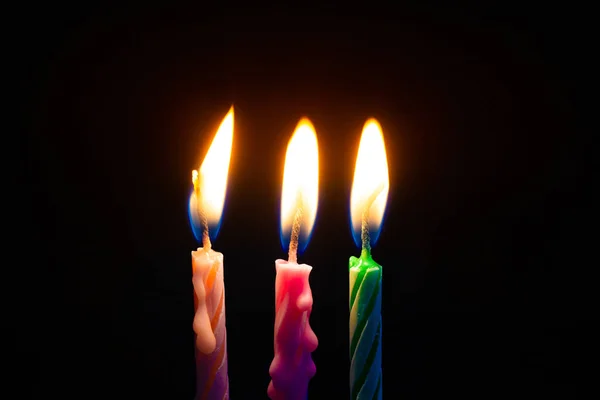 Three birthday candles on black background — Stock Photo, Image