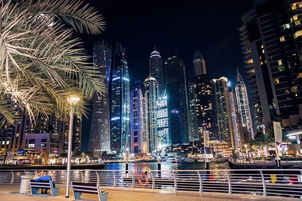 Dubai at night. Dubai marina, skylines Dubai Marina. Skyscrapers and Mosque of Dubai Marina in the evening. Ships and boats.