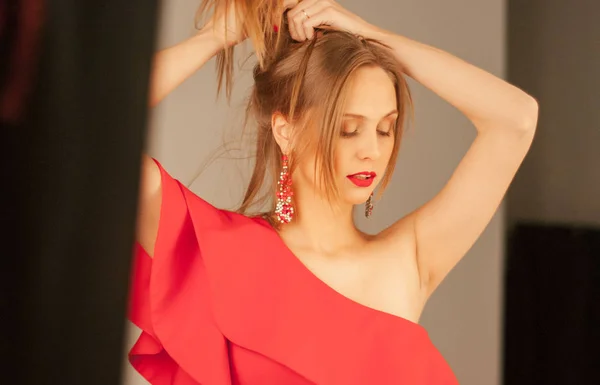 スタジオでポーズをとって赤いドレスを着ている美しい若い白人女性 — ストック写真