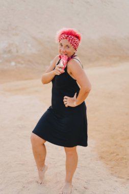 Girl with crimson short hair by the sea. Emotional girl.