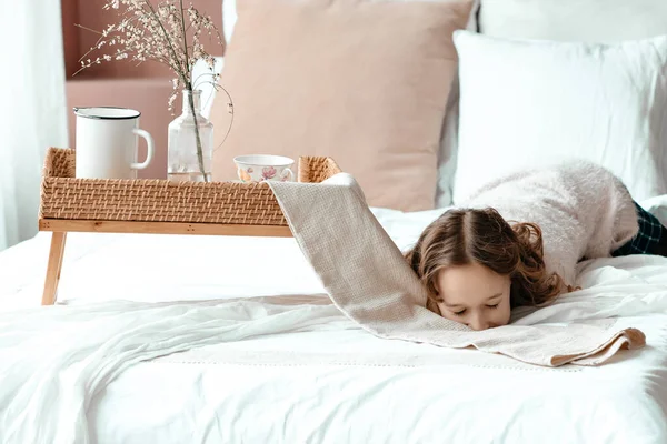 young girl  in bed with breakfast