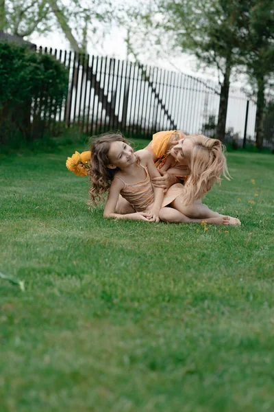 服を着た母と娘は休んでいて 芝生の夏のコテージにふけっています 夏休み — ストック写真