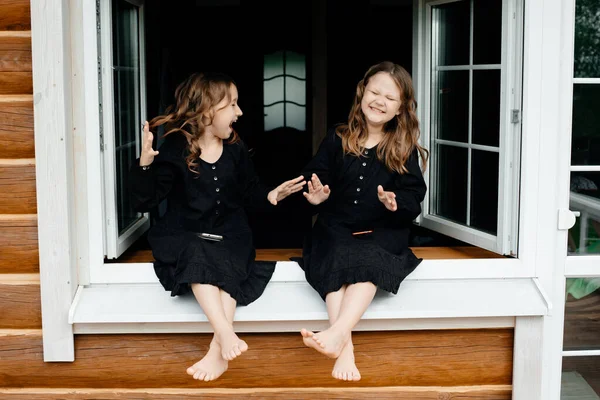 Little Girls Black Dresses Sitting Window Talking Phone Laughing Smiling — Stock Photo, Image