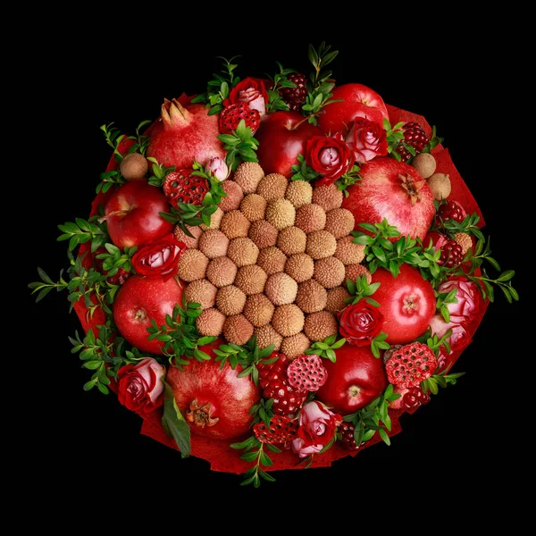 Unique homemade edible bouquet consisting of red fruits and flowers isolated on black background. Top view