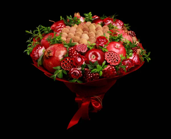 Unique homemade edible bouquet consisting of red fruits and flowers as a gift isolated on black background
