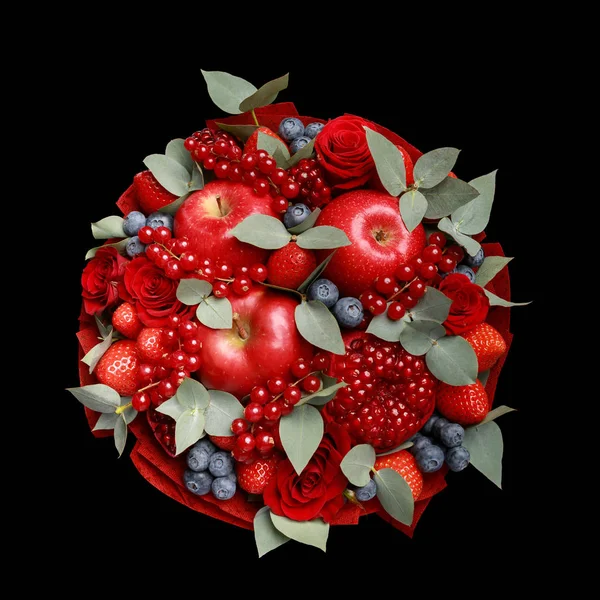 Beautiful bright red edible bouquet of fruits and flowers on a black background. Top view
