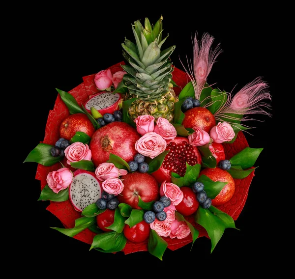Colorful bright unique bouquet of flowers and fruits isolated on black background. Top view