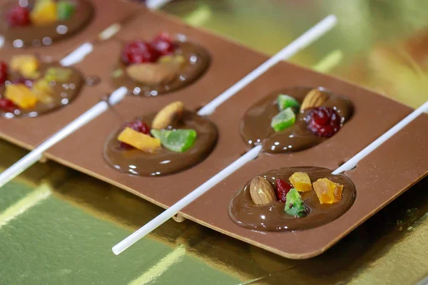 Handmade chocolate candies made from milk chocolate filled with nuts and dried fruits