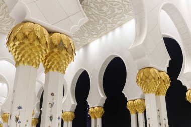 Abu Dabi, Bae, 10 Ocak 2019: Altın ve mozaik resimleri yle süslü mermer sütunlu Şeyh Zayed Ulu Camii'nin kemerlerine bakış