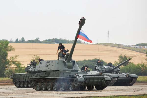 SAMBEK, ROSTOV REGION, RUSSIA, JUNE 28, 2019: International military technical forum ARMY-2019. Crew of tank get inside the self-propelled howitzer 2S3M Akatsiya