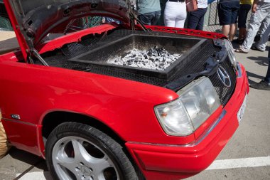 ROSTOV-ON-DON, RUSSIA, JUNE 16, 2019: Unique grill made under the hood of the old Mercedes car red color clipart