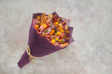 Açık arkaplanda sosis, peynir ve domateslerden oluşan lezzetli bir buket.