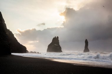 Reynisfjara ya da daha çok bilinen adıyla Kara Kum sahili gün doğumunda manzarası
