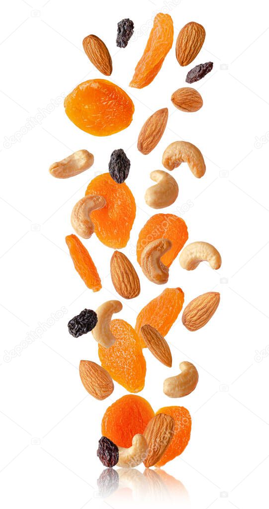 Flying dry fruits and nuts isolated on white.