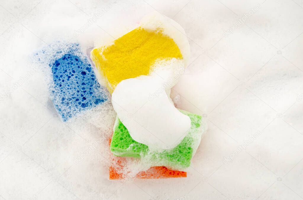 Soapy sponge with foam on white background. Cleaning concept