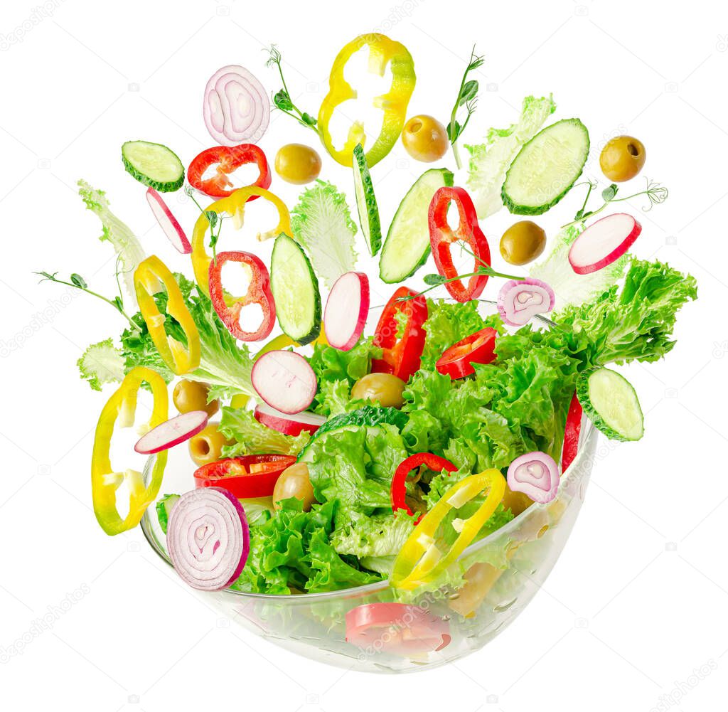 Fresh vegetable salad in transparent bowl with flying ingredients isolated on white. Proper nutrition.