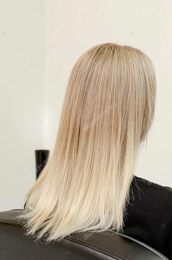 Modern trendy AirTouch technique for hair dyeing. Look from behind on straight hair