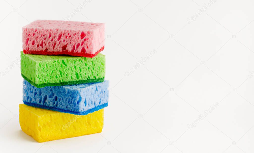 Stack of colorful sponges isolated on white. Dishwashing concept. Copy space.