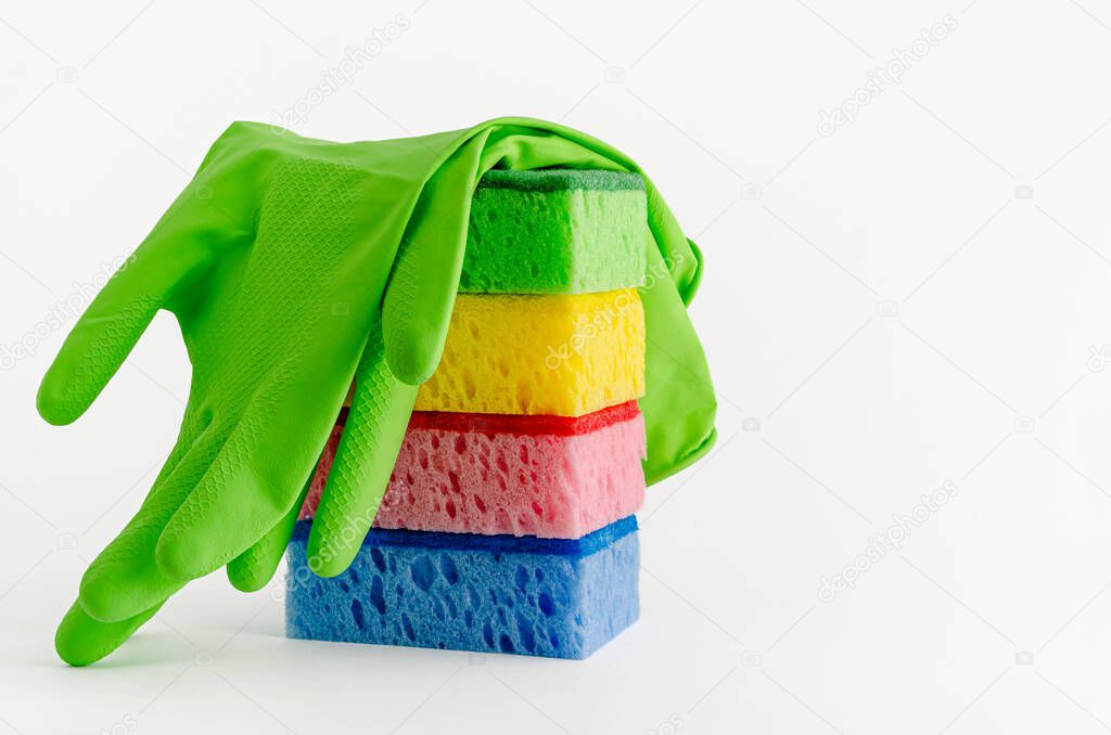 Latex gloves and stack of cleaning sponges isolated on white. Copy space