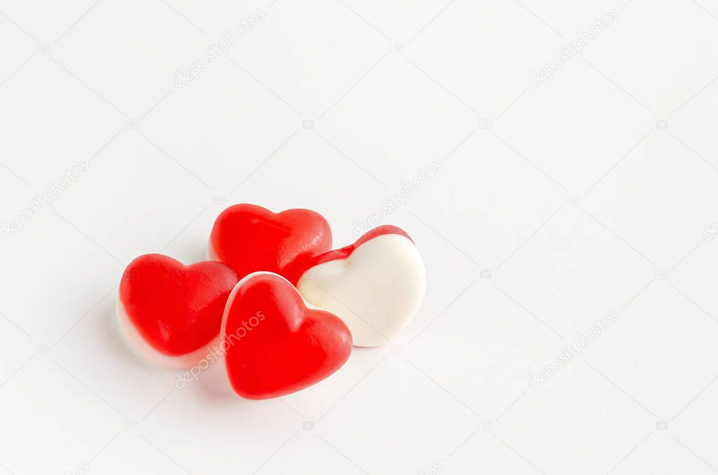 Heap of heart shaped jellies on white background. Valentines Day greeting card concept. Copy space