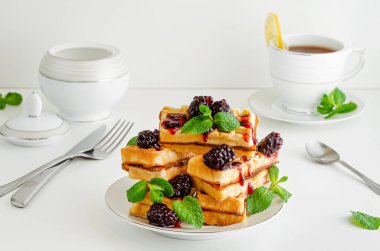 Böğürtlen reçelli Viyana waffle 'ı ve beyaz arka planda nane şekeri. Nefis kahvaltı..