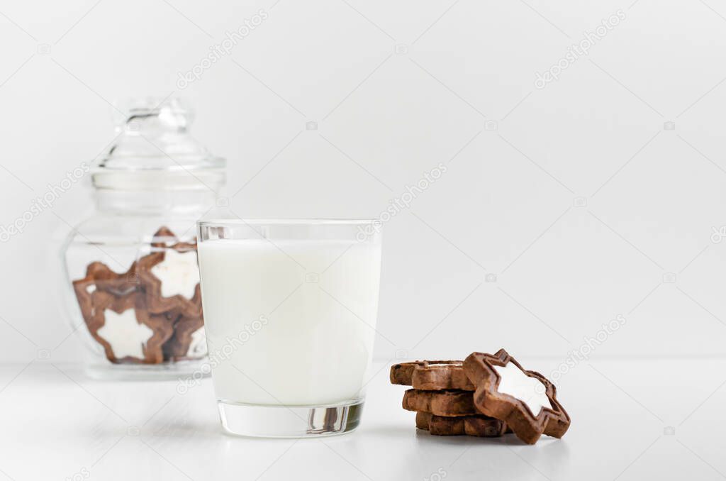 Healthy breakfast concept. A glass of fresh organic milk with biscuits in a star shape. Copy space