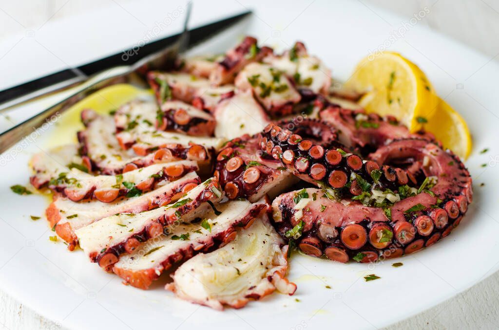 Seafood appetizer. Octopus Carpaccio on white plate. Mediterranean delicacy. Selective focus