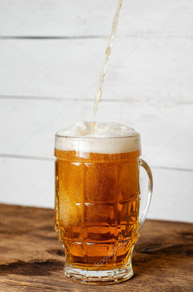 Beer pouring in a glass. Vertical, copy space