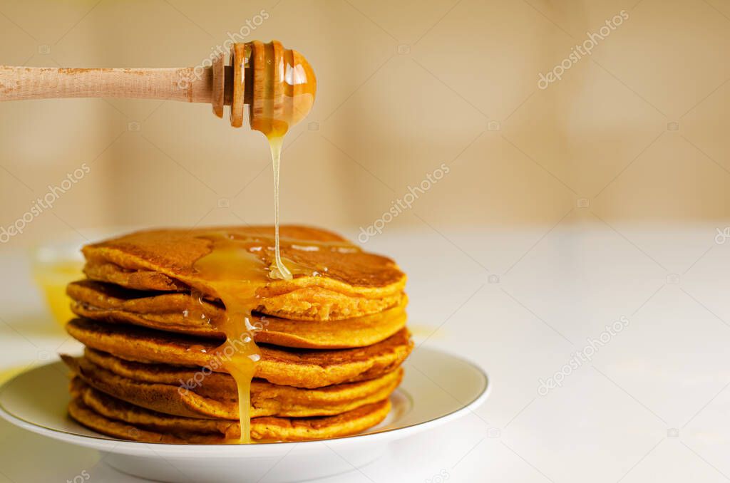 Delicious breakfast. Pancakes with honey. Nutrition concept. Copy space
