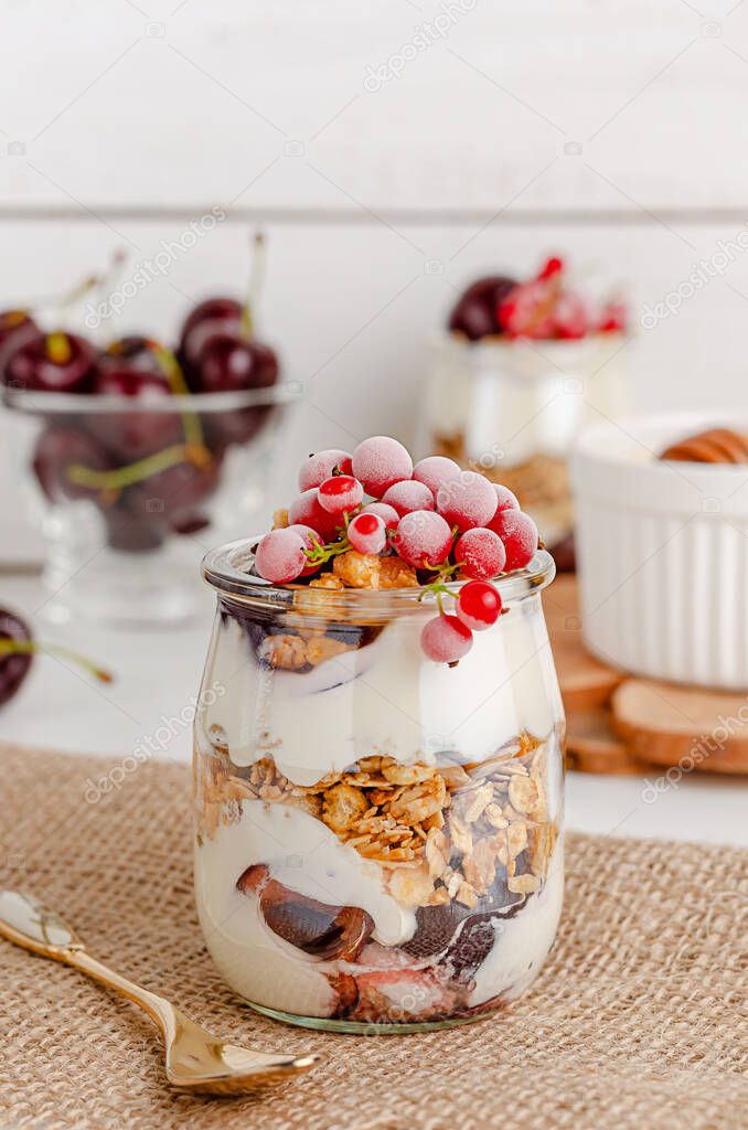 Breakfast cereal granola parfait with cherries and currants. Healthy eating concept