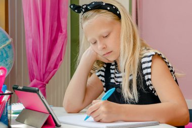Lovely caucasian left handed school girl bored while doing her homework. Education clipart