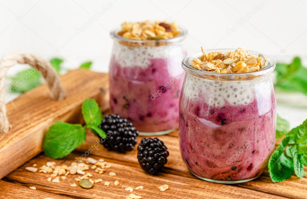 Jars of chia pudding dessert and fresh berries. Healthy dietary eating concept