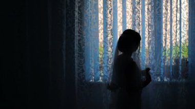 Bir gelin otel penceresinde yakınındaki bir silüeti