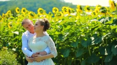 Mutlu çift el alarak ve gülümseyen ayçiçeği sahada çalışan.